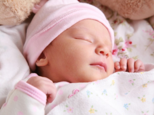 Portrait of a newborn girl sleeping.