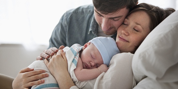 Caucasian couple holding baby